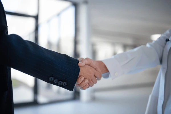 Business partnership handshake